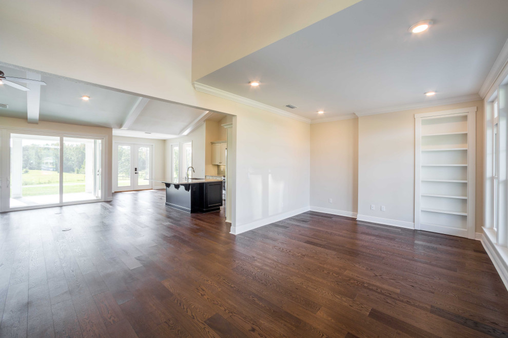 Mid-sized elegant medium tone wood floor and brown floor foyer photo with beige walls and a brown front door