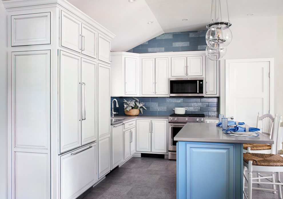 Mid-sized traditional l-shaped eat-in kitchen in New York with an undermount sink, raised-panel cabinets, white cabinets, quartz benchtops, grey splashback, porcelain splashback, panelled appliances, laminate floors, with island, grey floor and grey benchtop.