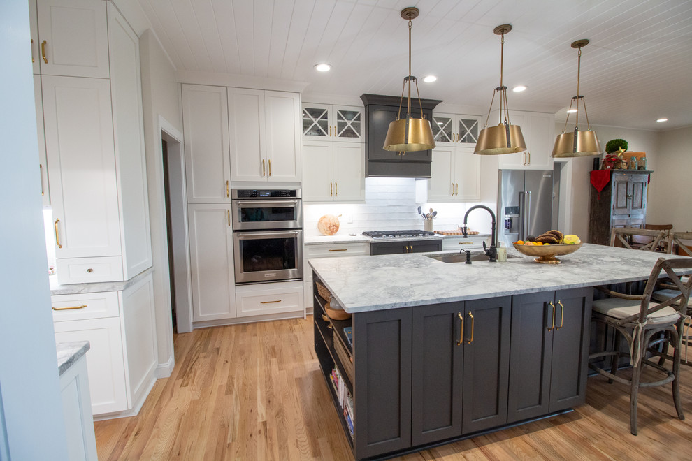 Inspiration for a large l-shaped eat-in kitchen remodel with shaker cabinets, white cabinets, granite countertops, an island and white countertops