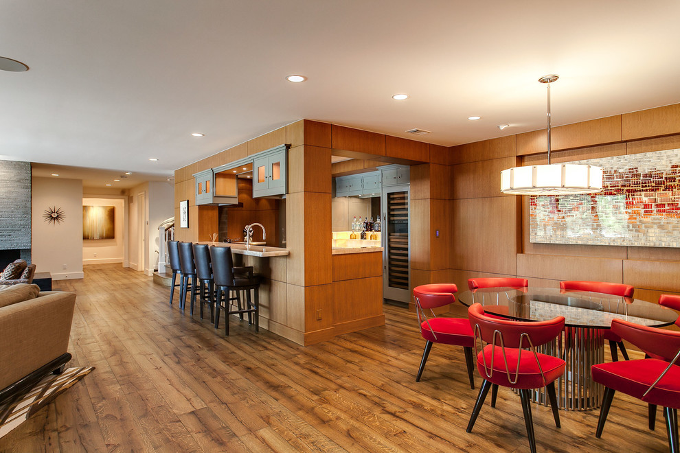 This is an example of a contemporary home bar in Denver with dark hardwood floors and brown floor.