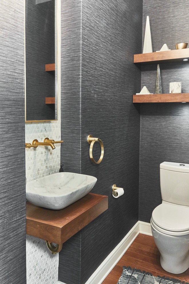 Design ideas for a small modern powder room in Philadelphia with open cabinets, medium wood cabinets, a two-piece toilet, multi-coloured tile, marble, white walls, medium hardwood floors, a vessel sink, marble benchtops, beige floor and white benchtops.
