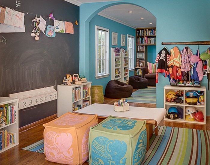 This is an example of a mediterranean gender-neutral kids' playroom for kids 4-10 years old in Los Angeles with blue walls and medium hardwood floors.