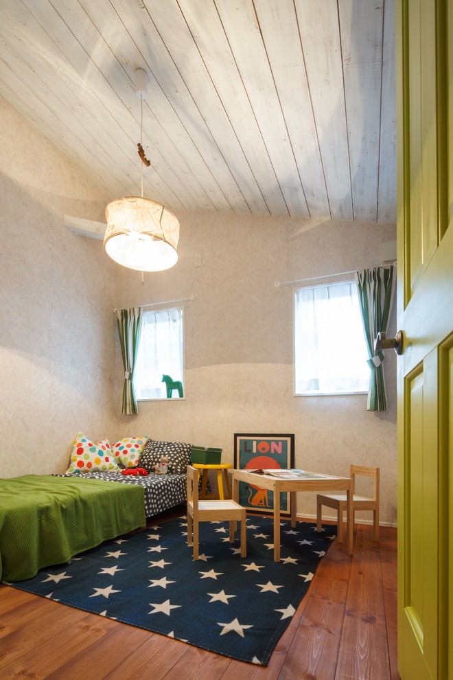 Midcentury kids' room in Other with beige walls, medium hardwood floors and brown floor.
