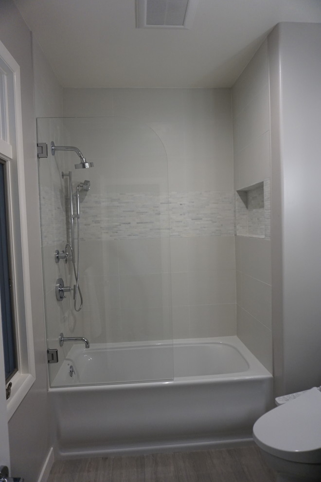 Photo of a mid-sized contemporary 3/4 bathroom in San Francisco with shaker cabinets, dark wood cabinets, an alcove tub, an alcove shower, white tile, porcelain tile, grey walls, porcelain floors, an integrated sink, solid surface benchtops, grey floor, a hinged shower door and white benchtops.
