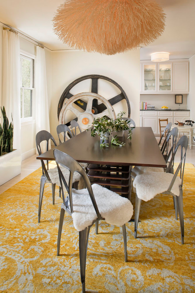 Eclectic dining room in San Francisco with white walls and light hardwood floors.