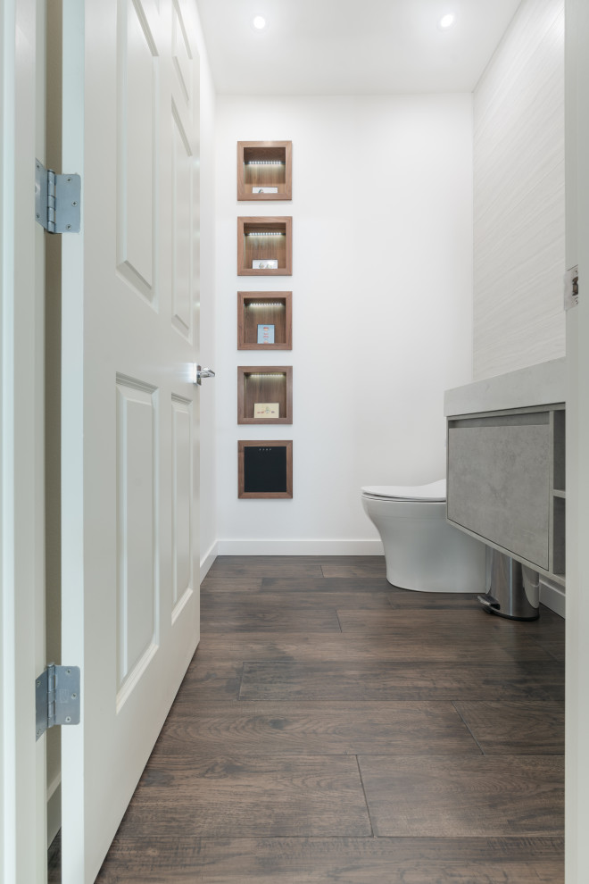 Powder room - small contemporary white tile and ceramic tile dark wood floor and brown floor powder room idea in Seattle with flat-panel cabinets, gray cabinets, a one-piece toilet, white walls, granite countertops, white countertops and a floating vanity