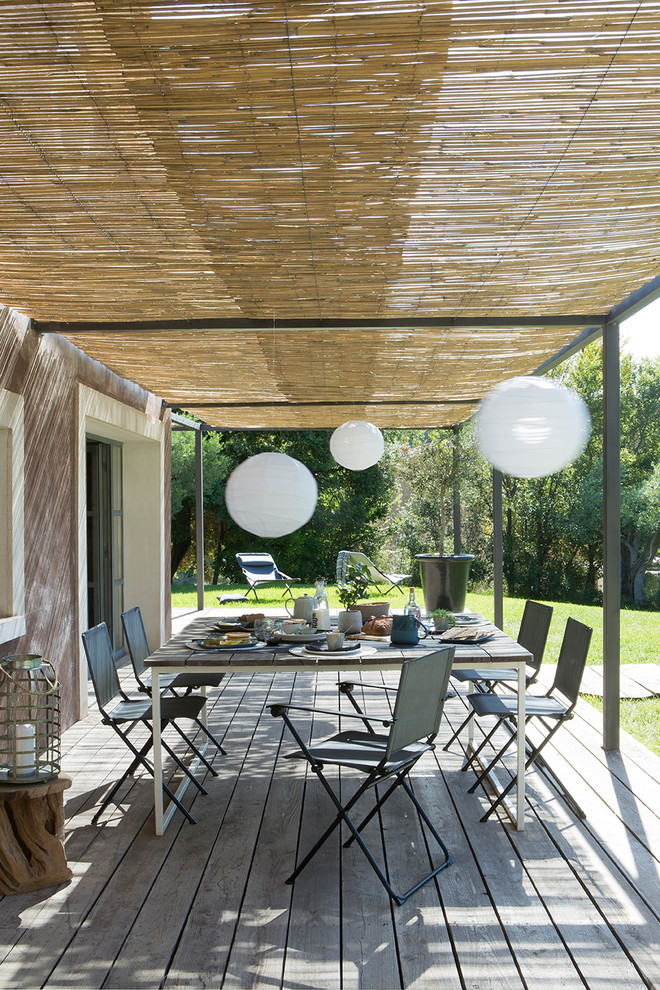 Photo of a mediterranean deck in Lyon with a pergola.