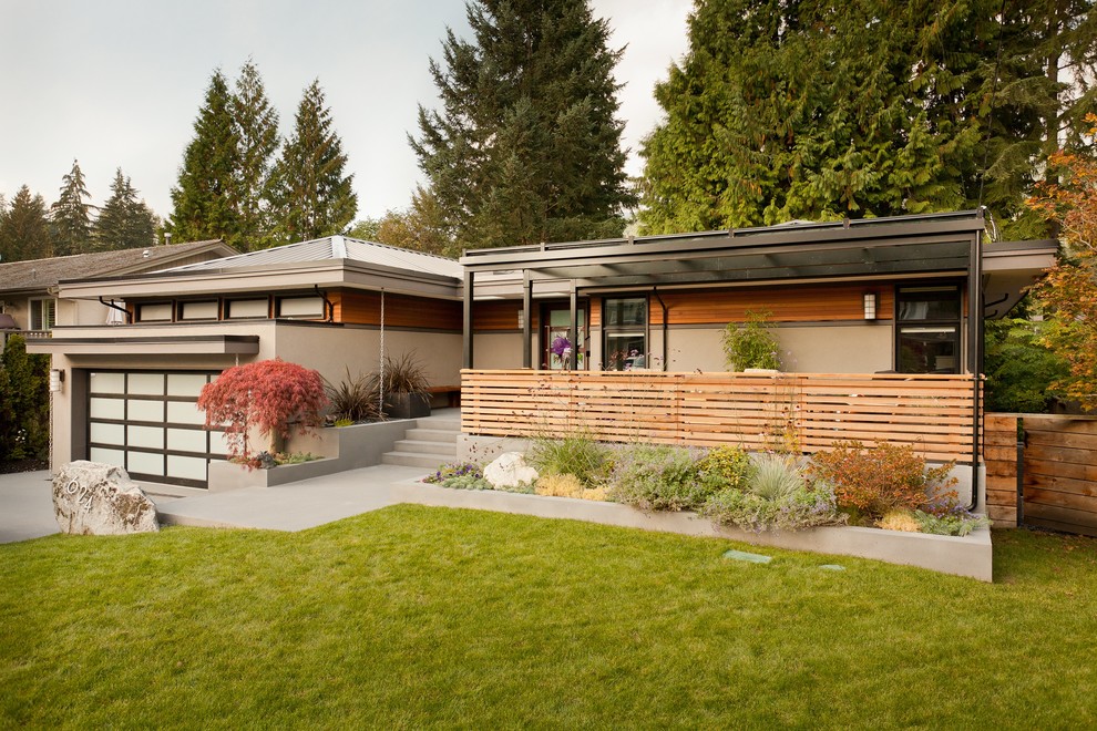 This is an example of a large contemporary two-storey stucco exterior in Vancouver.