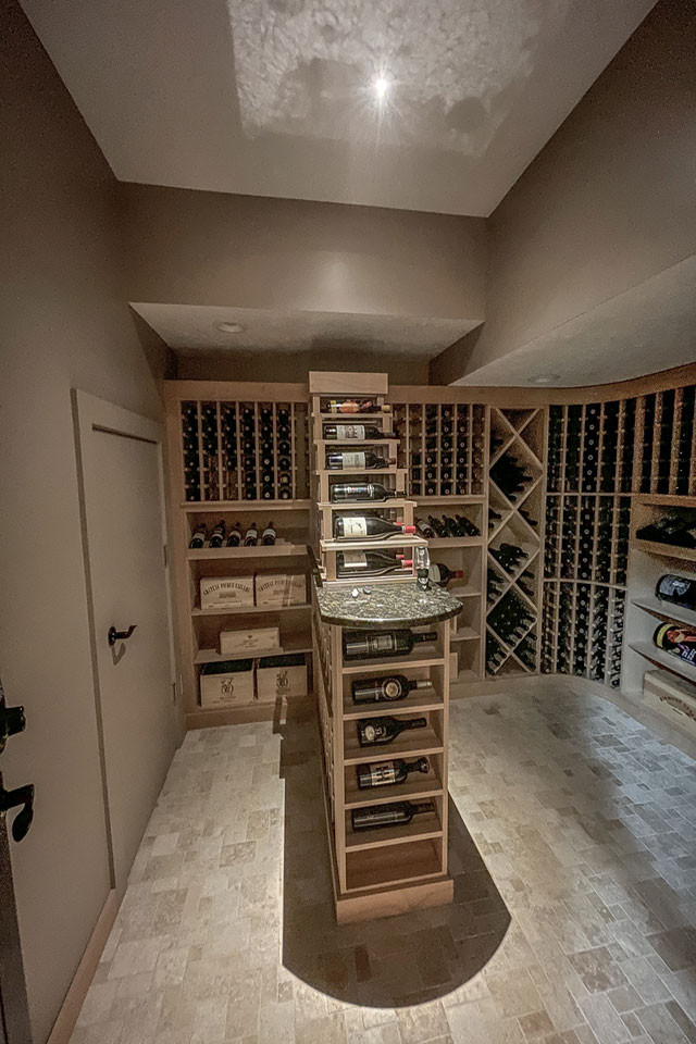 Mid-sized transitional wine cellar in Other with travertine floors, storage racks and beige floor.