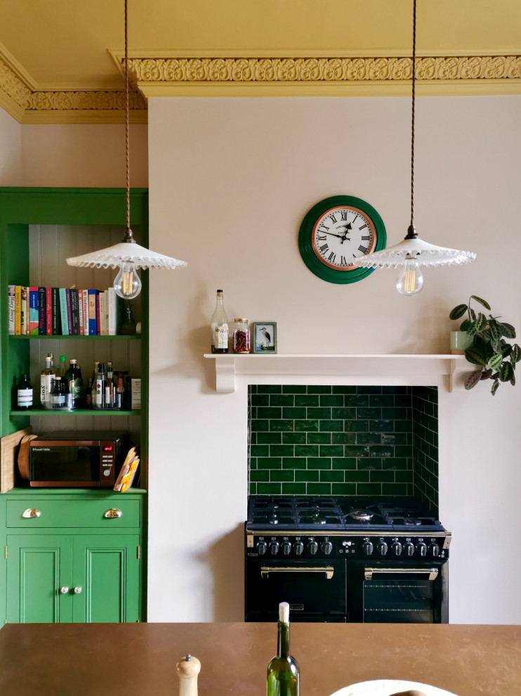 Mid-sized transitional eat-in kitchen in Other with a farmhouse sink, shaker cabinets, green cabinets, panelled appliances, medium hardwood floors, with island, brown floor, brown benchtop, copper benchtops, green splashback and ceramic splashback.