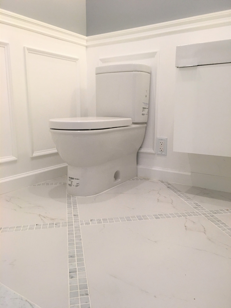 Design ideas for a small transitional powder room with flat-panel cabinets, white cabinets, a two-piece toilet, grey walls, marble floors, a console sink, solid surface benchtops, grey floor, white benchtops, a floating vanity and decorative wall panelling.