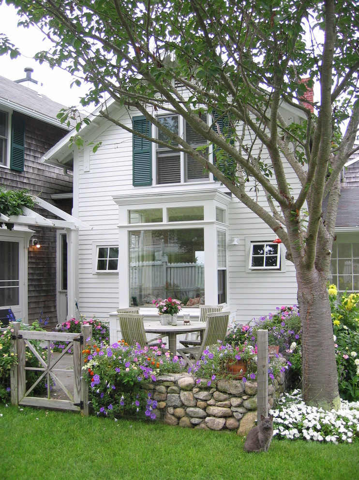 Inspiration for a traditional two-storey white exterior in Providence with wood siding.