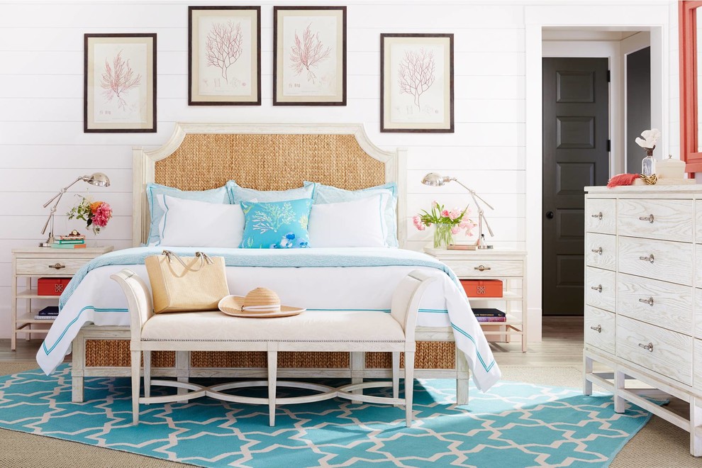 This is an example of a mid-sized beach style master bedroom in Orlando with white walls, light hardwood floors and no fireplace.