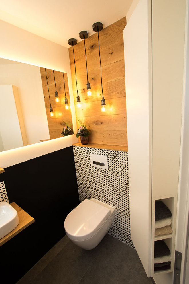 Photo of a small contemporary powder room in Other with white cabinets, black walls, a freestanding vanity and panelled walls.