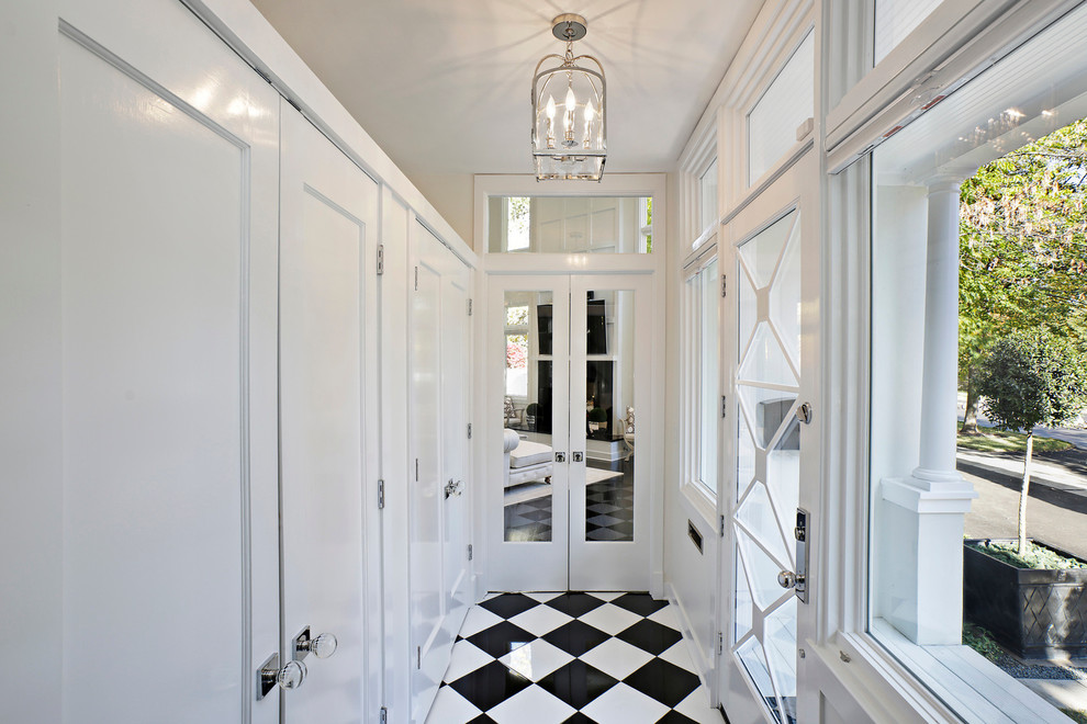 Transitional entry hall in Chicago with white walls.