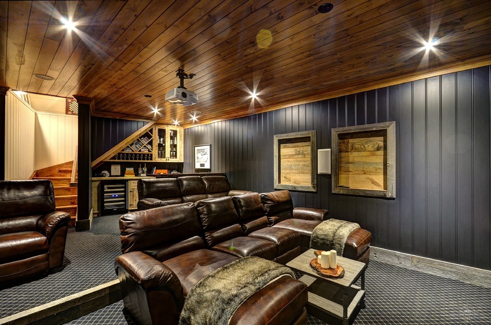 Photo of a country enclosed home theatre in Toronto with black walls, carpet and multi-coloured floor.