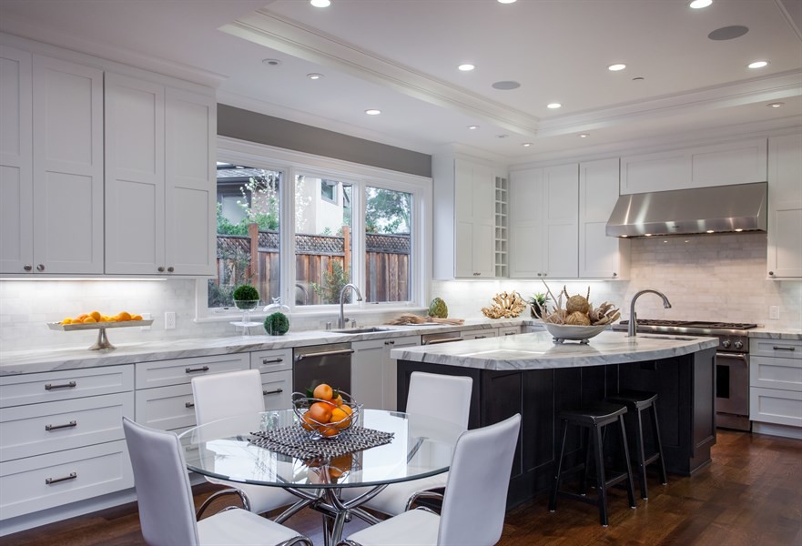 Inspiration for a mid-sized transitional l-shaped medium tone wood floor and brown floor enclosed kitchen remodel in San Francisco with an undermount sink, shaker cabinets, gray cabinets, marble countertops, gray backsplash, marble backsplash, stainless steel appliances and an island