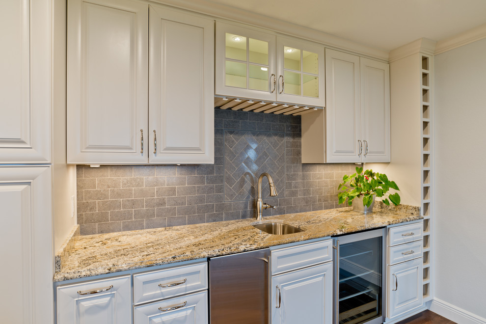 Large transitional galley porcelain tile eat-in kitchen photo in Miami with an undermount sink, raised-panel cabinets, white cabinets, granite countertops, gray backsplash, porcelain backsplash, stainless steel appliances and an island