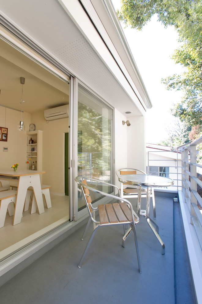 This is an example of a modern balcony in Other with no cover and metal railing.