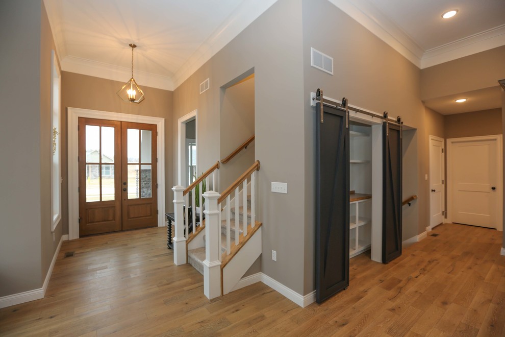 Transitional double front door photo with a medium wood front door