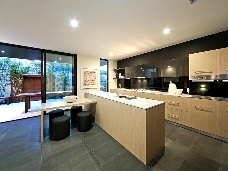 Photo of a mid-sized modern galley separate kitchen in Sydney with a drop-in sink, louvered cabinets, grey cabinets, laminate benchtops, white splashback, porcelain splashback, stainless steel appliances, porcelain floors and with island.