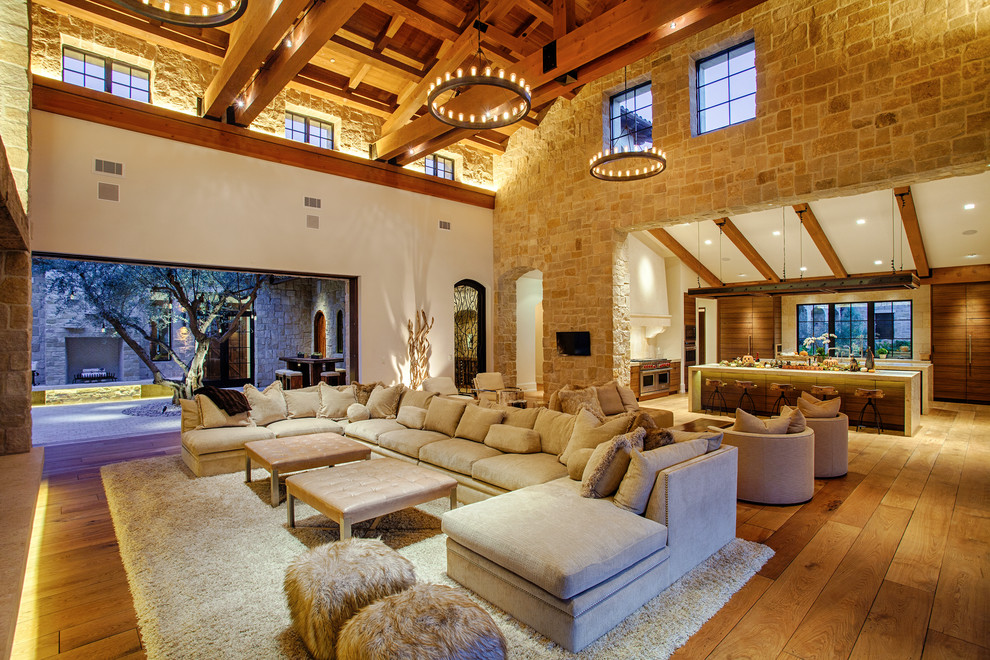 Inspiration for a mediterranean open concept living room in San Diego with beige walls and medium hardwood floors.
