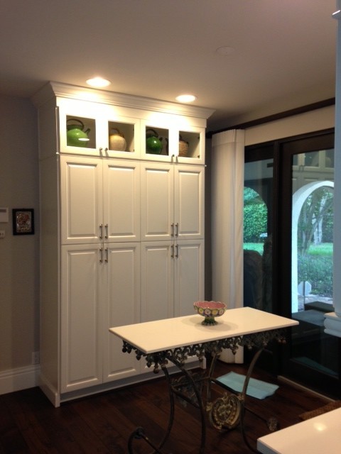 Example of a large transitional u-shaped ceramic tile eat-in kitchen design in Miami with an undermount sink, raised-panel cabinets, white cabinets, granite countertops, beige backsplash, stone tile backsplash, stainless steel appliances and an island