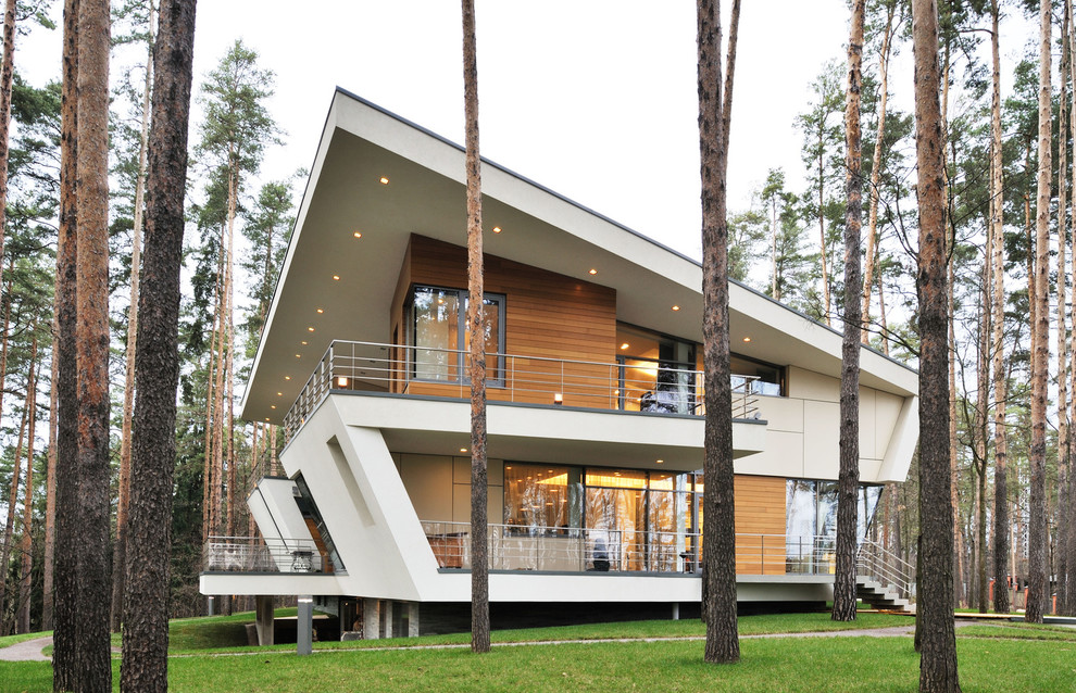 Inspiration for a large contemporary two-storey white exterior in Moscow with wood siding and a shed roof.