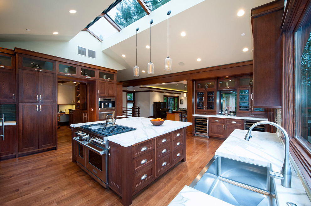 Contemporary u-shaped kitchen in San Francisco with a farmhouse sink, recessed-panel cabinets, dark wood cabinets, medium hardwood floors and brown floor.
