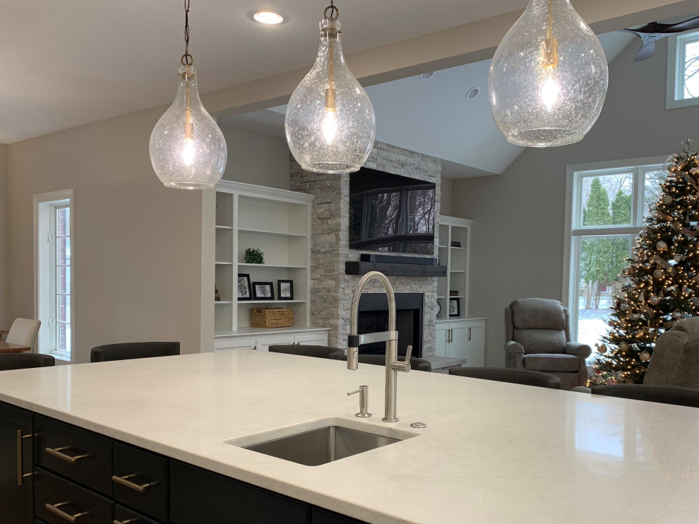 Inspiration for a large transitional l-shaped kitchen remodel in Milwaukee with an undermount sink, recessed-panel cabinets, quartz countertops, an island and white countertops