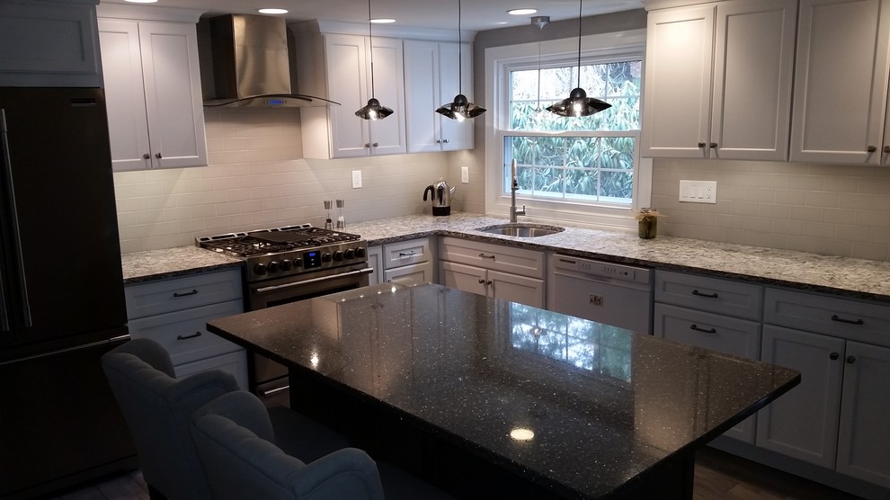 Mid-sized transitional u-shaped porcelain tile and gray floor eat-in kitchen photo in Boston with an undermount sink, gray cabinets, quartz countertops, stainless steel appliances, an island, recessed-panel cabinets, white backsplash, subway tile backsplash and white countertops