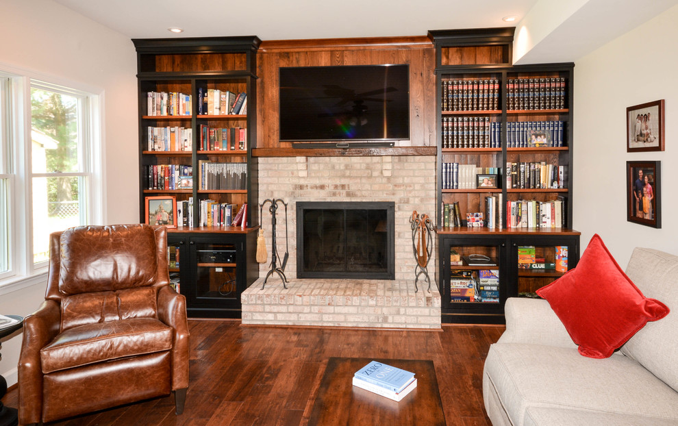 Inspiration for a small country open concept family room in DC Metro with a game room, white walls, medium hardwood floors, a standard fireplace, a wood fireplace surround and a wall-mounted tv.