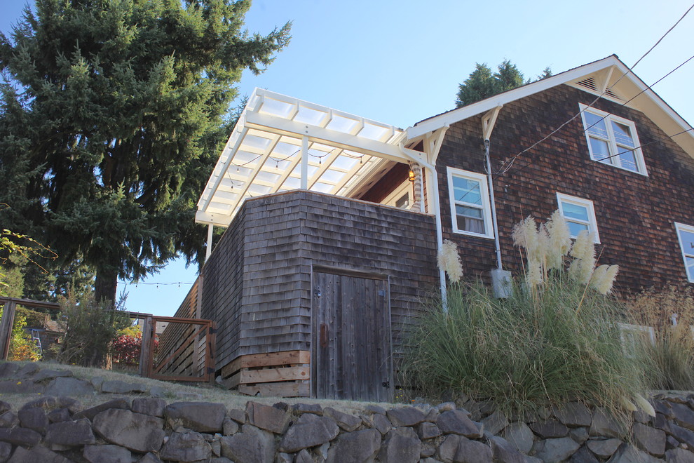 Deck - mid-sized craftsman backyard deck idea in Seattle with a pergola