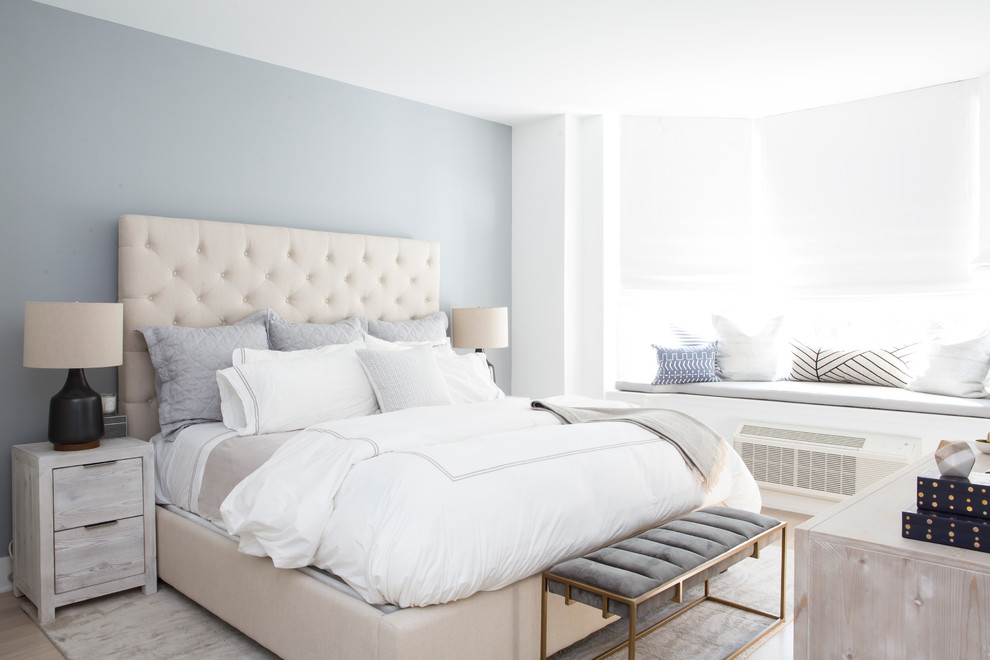 Transitional bedroom in New York with blue walls.