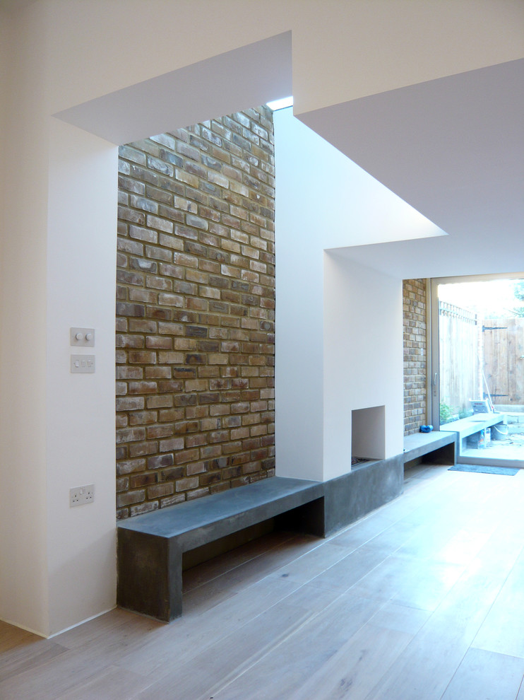 Contemporary living room in London with a standard fireplace and a plaster fireplace surround.