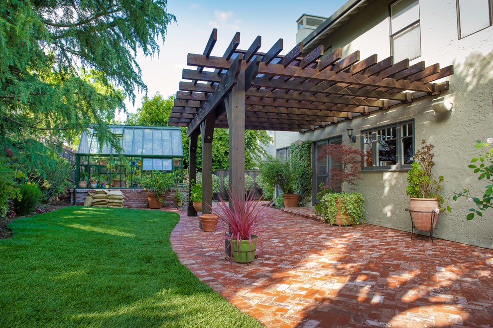 Mid-sized traditional backyard patio in San Francisco with a container garden, brick pavers and a pergola.