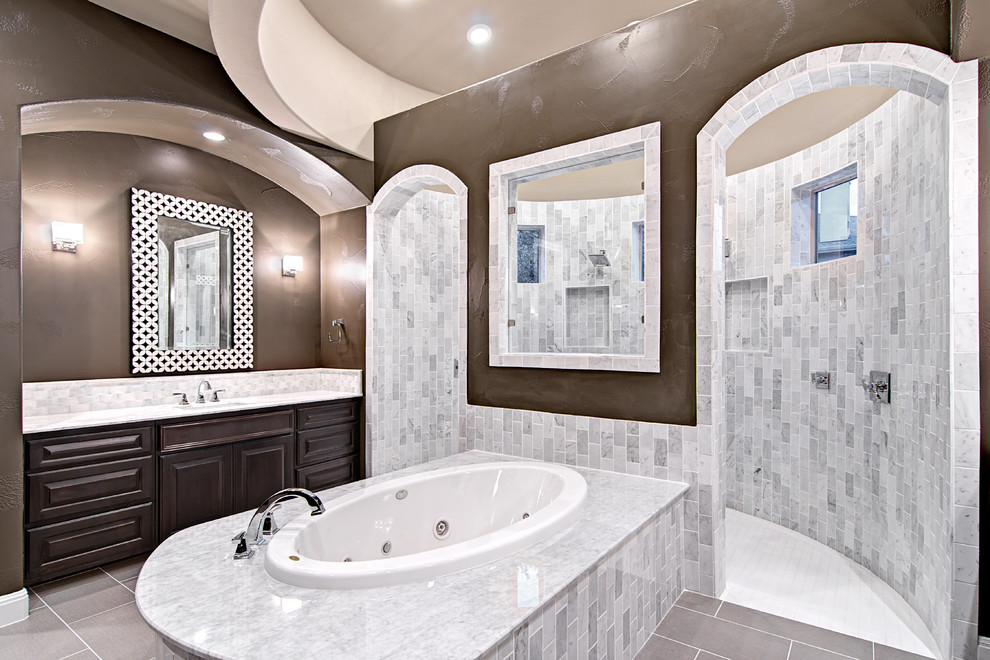 Design ideas for a traditional bathroom in Austin with a drop-in tub, a double shower, white tile and stone tile.