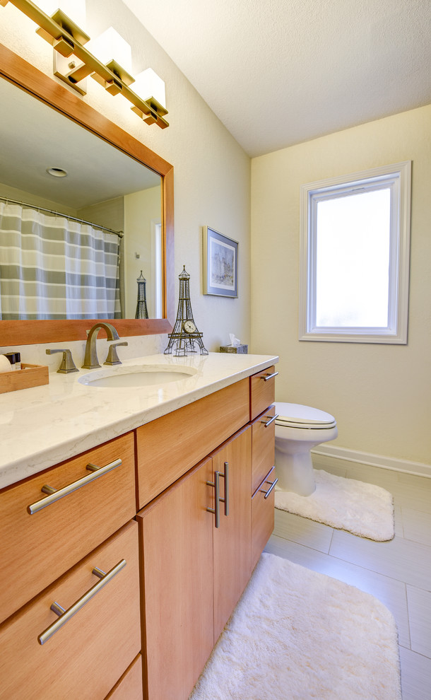 Inspiration for a mid-sized contemporary master bathroom in Other with flat-panel cabinets, quartzite benchtops, an undermount tub, a two-piece toilet, ceramic tile, medium wood cabinets, an alcove shower, white walls, porcelain floors, an undermount sink, beige tile and white tile.