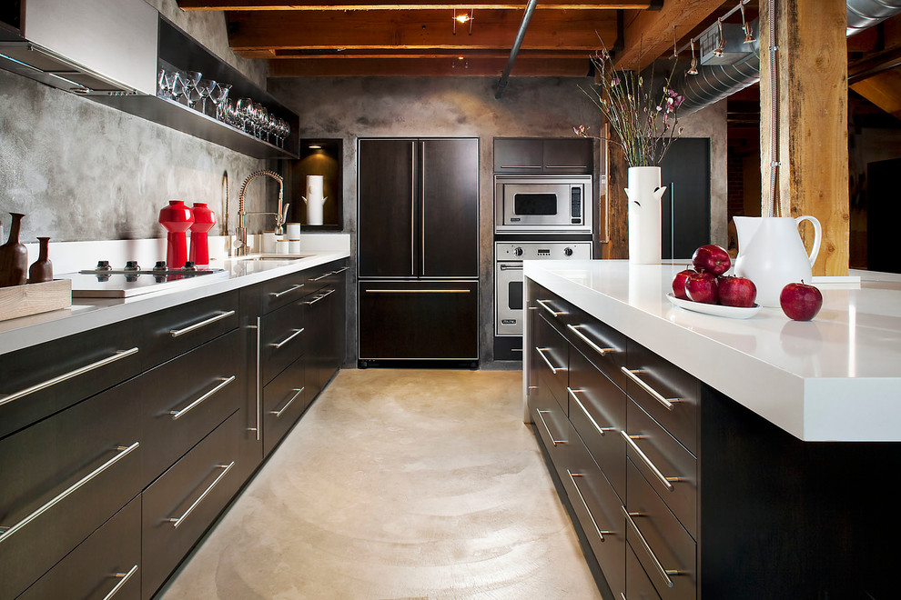 Industrial u-shaped kitchen in San Francisco with an undermount sink, flat-panel cabinets, dark wood cabinets, panelled appliances and with island.