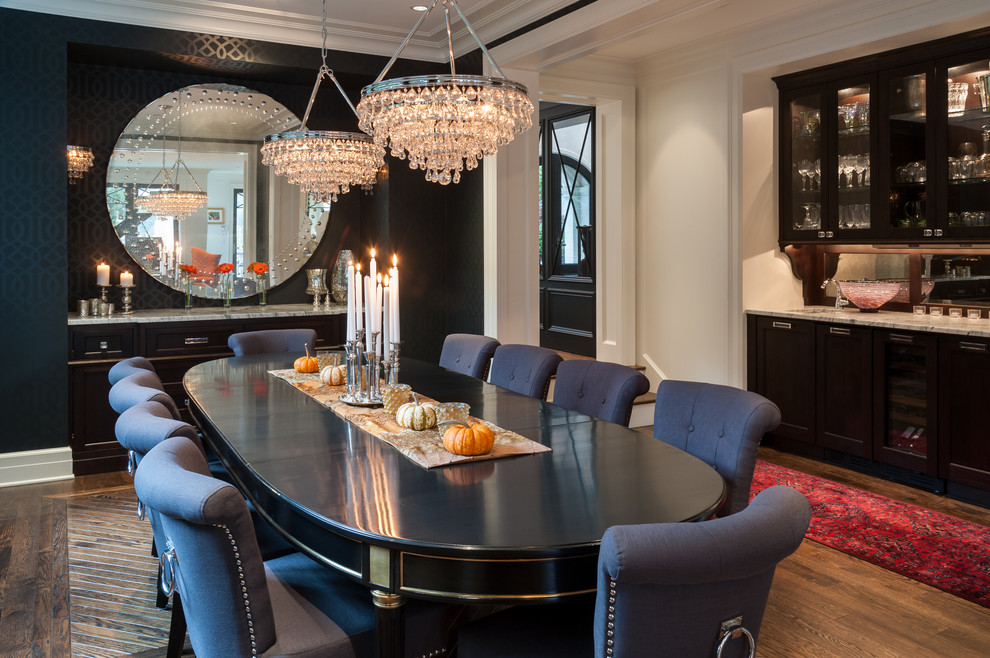 Transitional medium tone wood floor enclosed dining room photo in Seattle with black walls