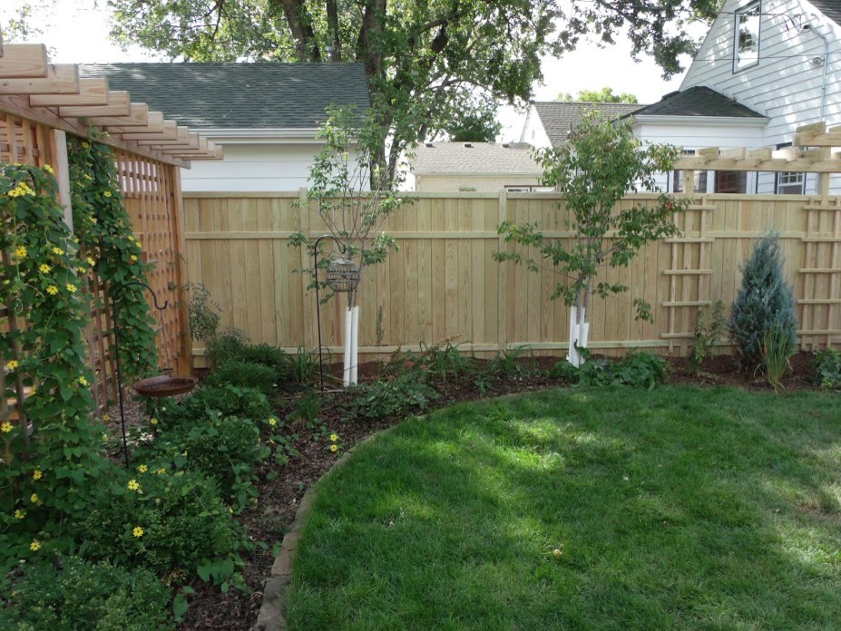 Inspiration for a large contemporary partial sun backyard gravel landscaping in Minneapolis with a pergola for summer.