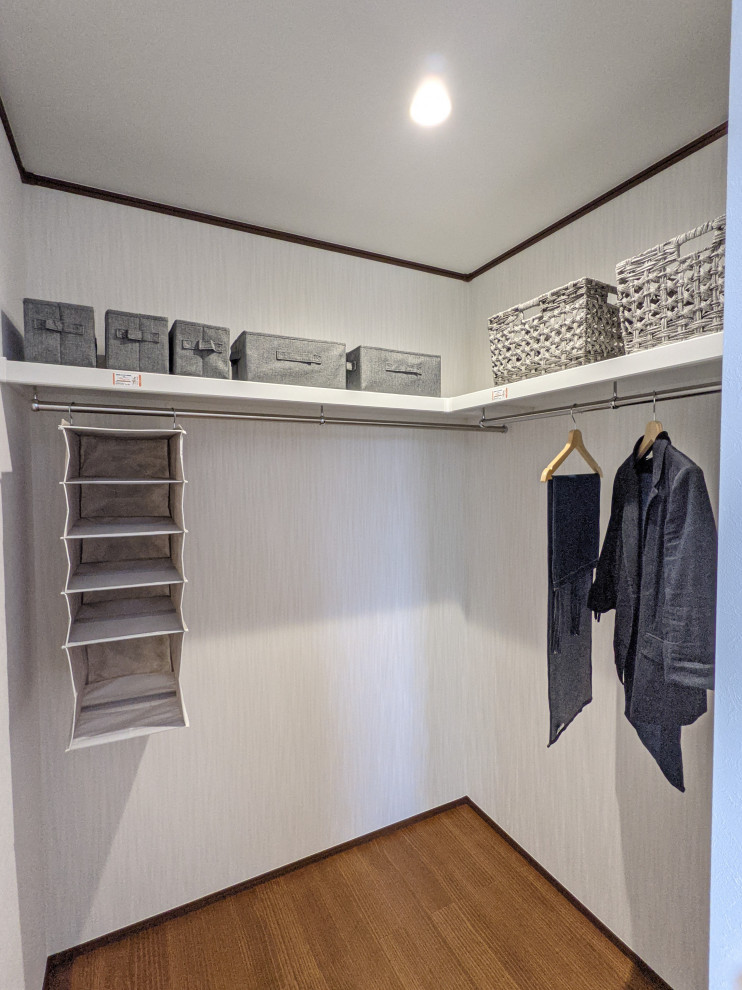 Design ideas for a modern wardrobe in Other with dark hardwood flooring, brown floors and a wallpapered ceiling.
