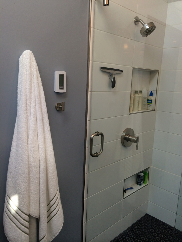 Photo of a small modern bathroom in Seattle with an integrated sink, shaker cabinets, white cabinets, concrete benchtops, an alcove shower, a two-piece toilet, white tile, ceramic tile, blue walls and porcelain floors.