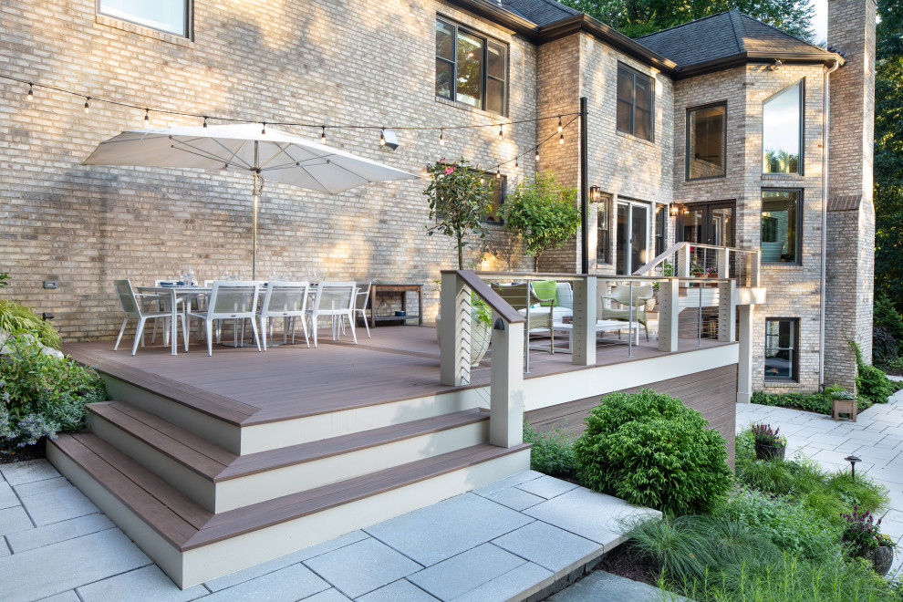 Example of a transitional backyard second story cable railing deck design in DC Metro