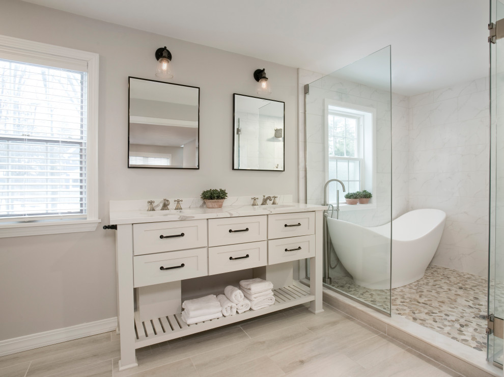 Inspiration for a large transitional master wet room bathroom in Boston with white cabinets, a freestanding tub, a one-piece toilet, white tile, porcelain tile, beige walls, wood-look tile, an undermount sink, engineered quartz benchtops, beige floor, an open shower, white benchtops, a double vanity, a freestanding vanity and shaker cabinets.
