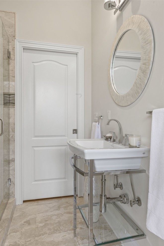 Mid-sized transitional 3/4 beige tile and marble tile marble floor and beige floor alcove shower photo in Jacksonville with a two-piece toilet, beige walls, a console sink and a hinged shower door