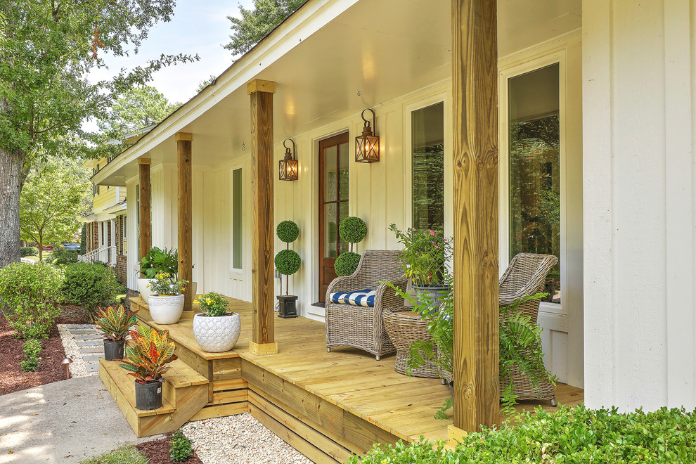Inspiration for a country front yard verandah in Charleston with decking and a roof extension.