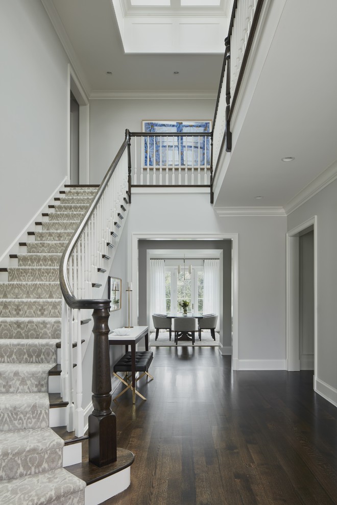 Traditional foyer in Chicago with grey walls, dark hardwood floors and brown floor.