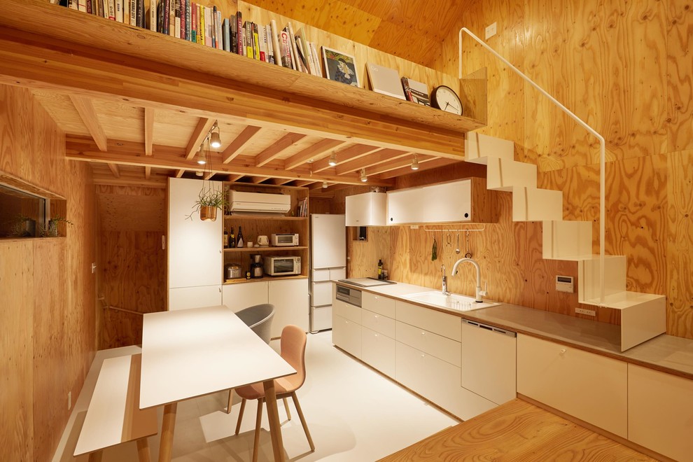 Inspiration for a small arts and crafts single-wall open plan kitchen in Tokyo with white cabinets, white splashback, timber splashback, stainless steel appliances, no island, white floor and grey benchtop.