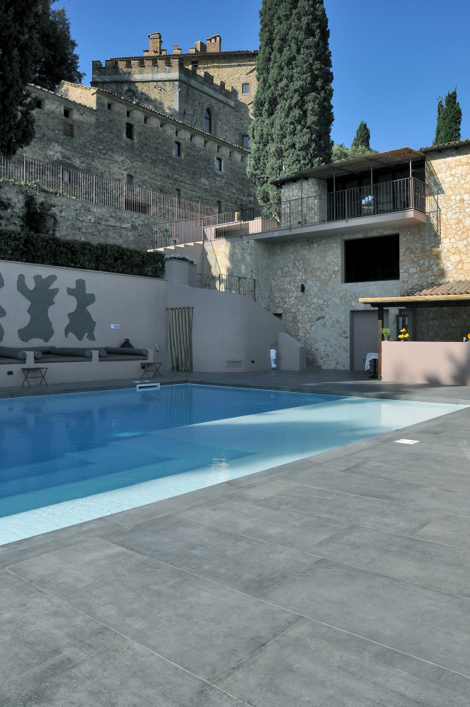 This is an example of a modern rectangular pool with with a pool and tile.